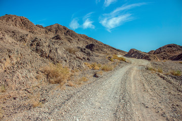 desert sand stone rocky dry scenery landscape country side wasteland environment with lonely trail 