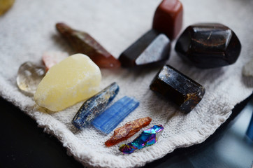 Bright, healing crystals assortment, crystal collection displayed. Mystical, low exposure macro photo of crystals. Healing stones, witchy decoration. Wiccan alter, bohemian colors, crystal witchcraft.