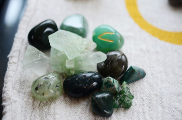 Lush green crystal collection, Green Quartz, Malachite, Peridot, Fluorite, rainforest jasper, and Quantum Quattro. Prosperity and abundance healing crystal collection. White background, bright colors