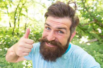 Perfect hair length for his face shape. Happy man with styled hair giving like hand. Hairy guy with...