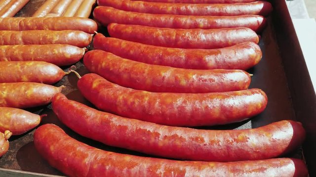 Big sausages on grilling pan close-up