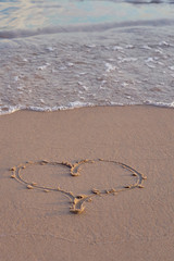 Heart written on sand on the beach. 