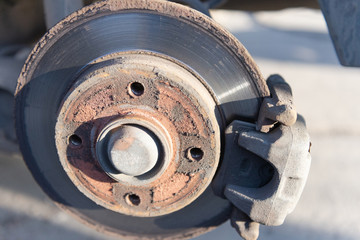 Car brakes. Work in tire shop. Brake disc after removing the wheel.
