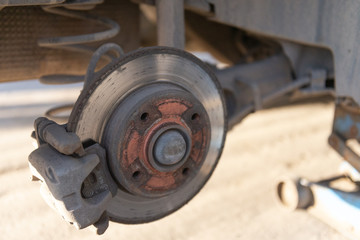 Car brakes. Work in tire shop. Brake disc after removing the wheel.