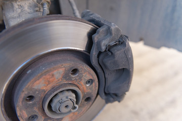 Car brakes. Work in tire shop. Brake disc after removing the wheel.