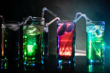 collection of colorful shots with lemon on bar; set of alcohol mini cocktail shooters with lime;