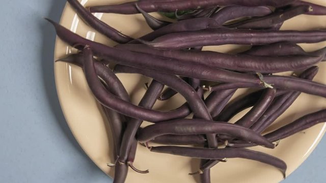 Purple beans plate top view, rotation