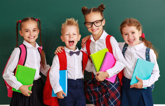 funny group children   schoolboy  and schoolgirl, student boy  and girl about school blackboard