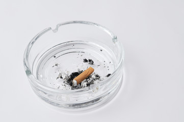 Cigarette in ashtray isolated on white background