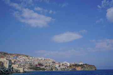 Fototapeta na wymiar Hermoupolis, Syros, Greece: View from the breakwater of a cloud formation over the coast of Syros, a Cyclades Island in Greece.