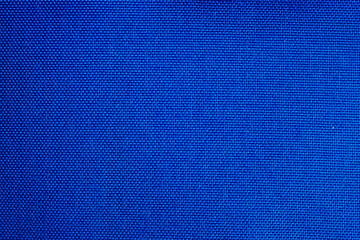 Bright blue color textile fabric surface close up macro texture background.