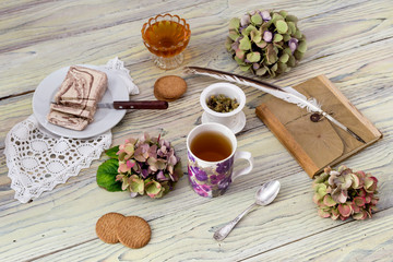 Obraz na płótnie Canvas Herbal tea and confection on a wooden table