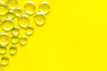 Pattern from colored glass stones on yellow background top view mockup
