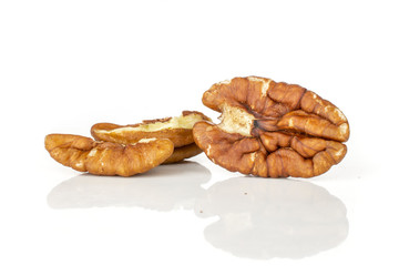 Group of one whole two halves of bright fresh brown pecan nut half isolated on white background