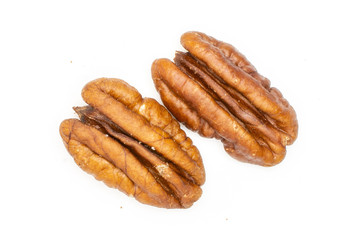 Group of two whole unshelled fresh brown pecan nut half flatlay isolated on white background