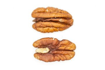 Group of two whole fresh brown pecan nut half comparing flatlay isolated on white background