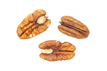 Group of three whole fresh brown pecan nut half flatlay isolated on white background