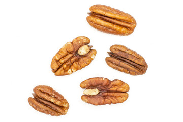 Fototapeta na wymiar Group of five whole fresh brown pecan nut half flatlay isolated on white background