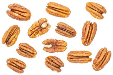 Lot of whole fresh brown pecan nut half flatlay isolated on white background