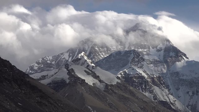 Locked shot of clouds moving over Mount Everest, famous mountain peak seen from basecamp in Tibet and China