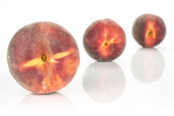 Group of three whole fresh red peach placed diagonally isolated on white background