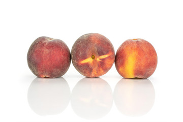 Group of three whole fresh red peach in a row isolated on white background