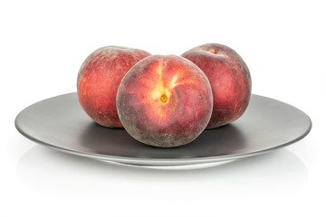 Group of three whole fresh red peach on a gray ceramic plate isolated on white background