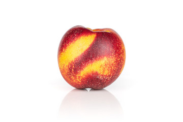 One whole fresh red nectarine isolated on white background