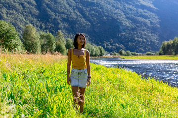 woman traveler enjoying the scenic view of the Norwegian countryside in summer