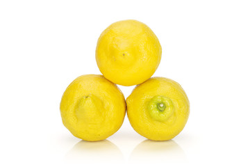 Group of three whole fresh yellow lemon arranged in a pyramid isolated on white background