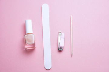 Manicure tools on pink background