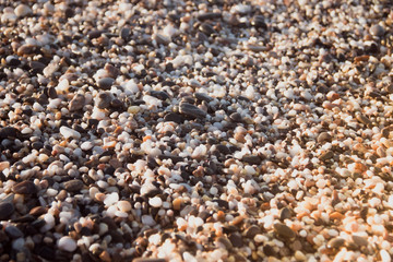 Stones on a background of a sea wave. Background stones and wave. Sea wave. Galichny beach.