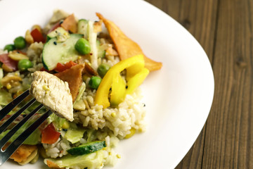 Tasty healthy dinner with chicken meat, fresh vegetables and rice on table, close up