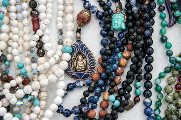 Close-up details of many yoga prayer malas. - Powered by Adobe