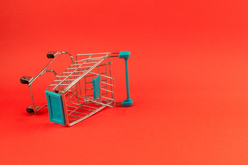 empty shopping cart on bright red background