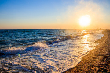 Fototapeta premium Sea waves. Sea of Crimea. High waves at sunset. Sunny day at sea. Background blue waves. Sand beach. Clean beach.