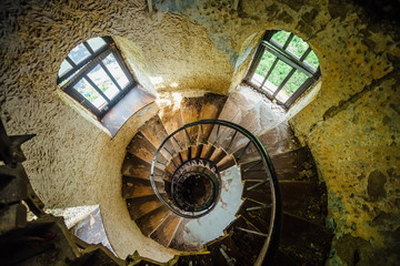 Old spiral staircase in abandoned mansion, upside view