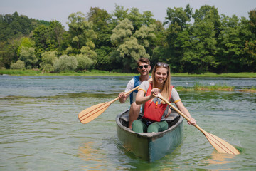 couple of explorers conoining on wild river