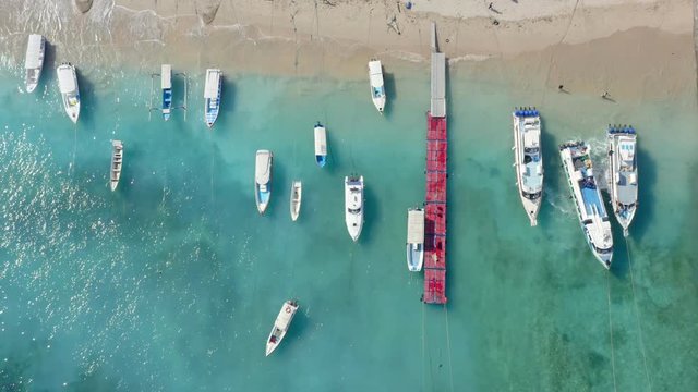 Holiday Concept. Beautiful Top Down Drone Shot of Ships on Toya Pakeh Harbour. Nusa Penida, Bali - Indonesia