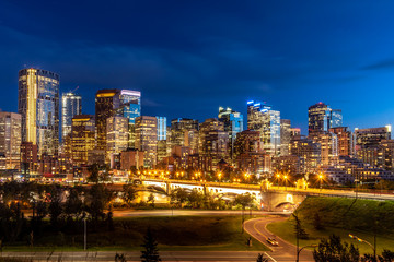 Calgary's skyline along the Bow River at sunset. 