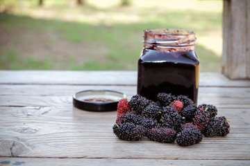 home made mulberry jam and fresh mulberry on wood background, Healthy eating and very useful.