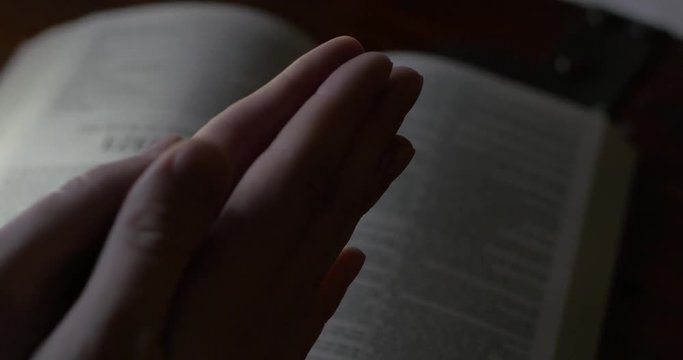 4K Rack Focus of Hands Praying Over Bible and Man Practicing his Religion