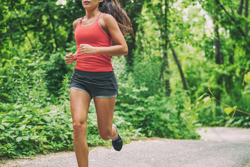 Woman runner on city run marathon race running jogging outdoors in summer active sport lifestyle....