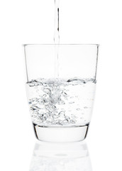 water pouring into a tumbler glass isolated on white background. with clipping path.
