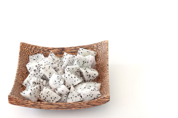 Sliced piece dragon fruit or Pitaya in wooden plate isolated on white background.