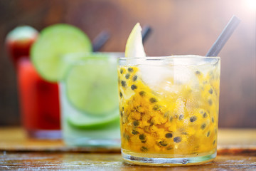 Traditional brazilian caipirinha alcoholic cocktail with sugar, mint and brown sugar. Fruit with cachaça, Brazilian tradition.