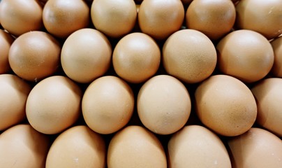 background of fresh eggs for sale at a market, many fresh brown eggs for sale at a market