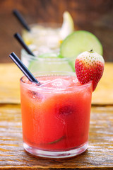 Traditional brazilian caipirinha alcoholic cocktail with sugar, mint and brown sugar. Fruit with cachaça, Brazilian tradition.