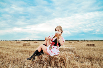 Beautiful caucasian woman with beer in dress. Octoberfest festival.