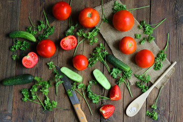 vegetables - tomatoes and cucumbers on a wooden board.